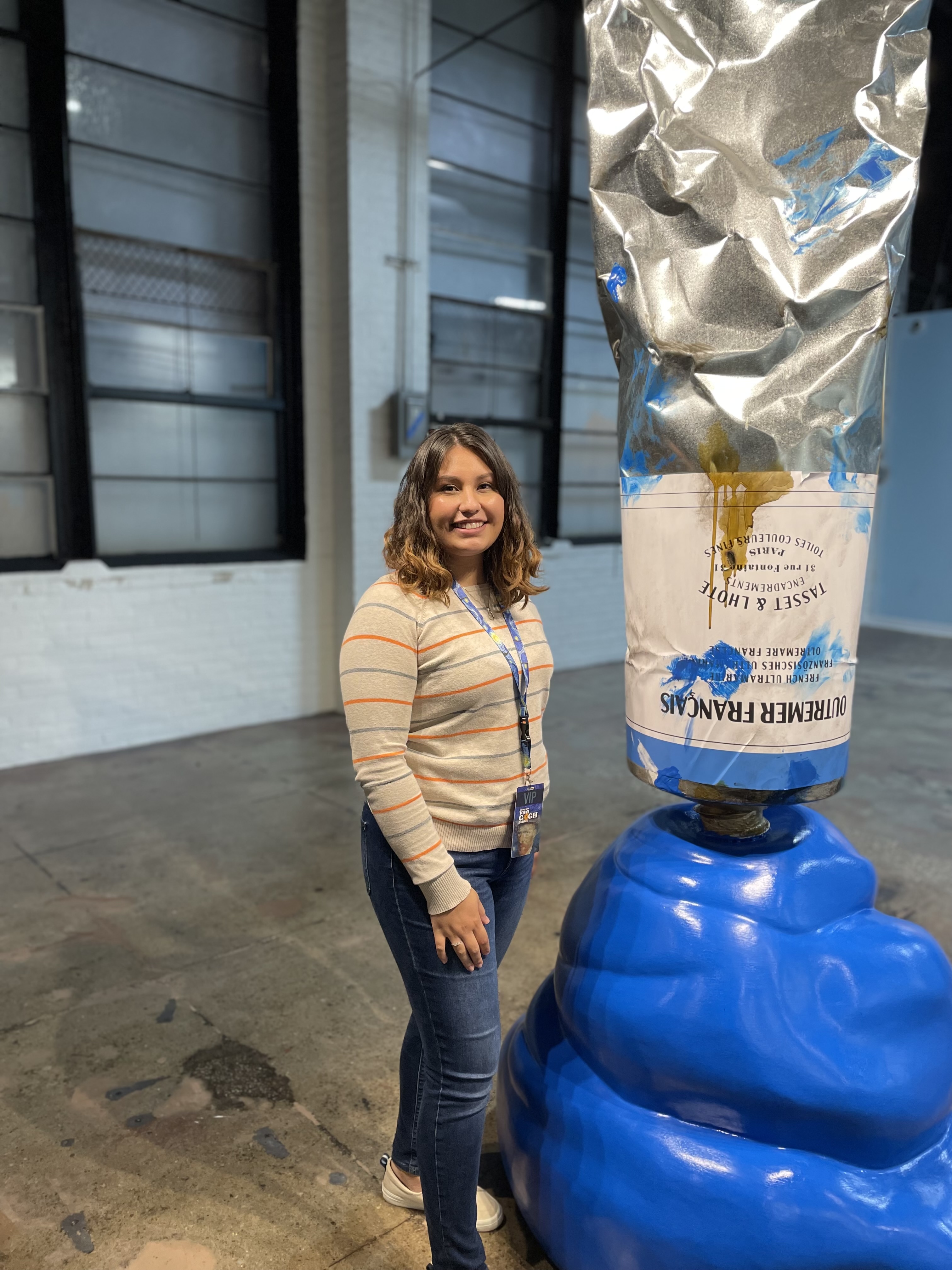 Adriana next to giant paint bottle